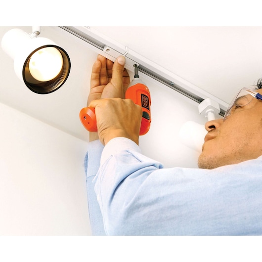 BLACKDECKER 9036 cordless screwdriver in use, person installing a ceiling fixture near a track light.