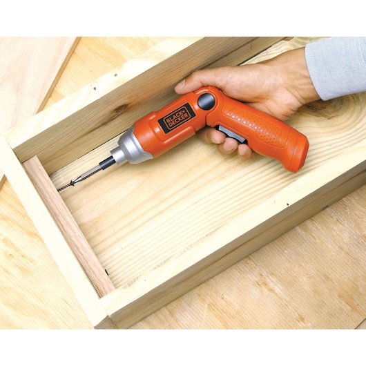 Photo of BLACKDECKER 9036 orange cordless screwdriver used to assemble wooden boards.