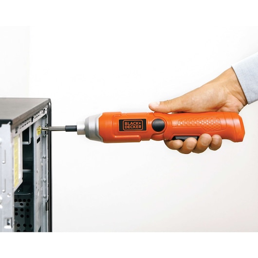 Photo of BLACK+DECKER orange electric screwdriver 9036 used to tighten a screw in a computer case.