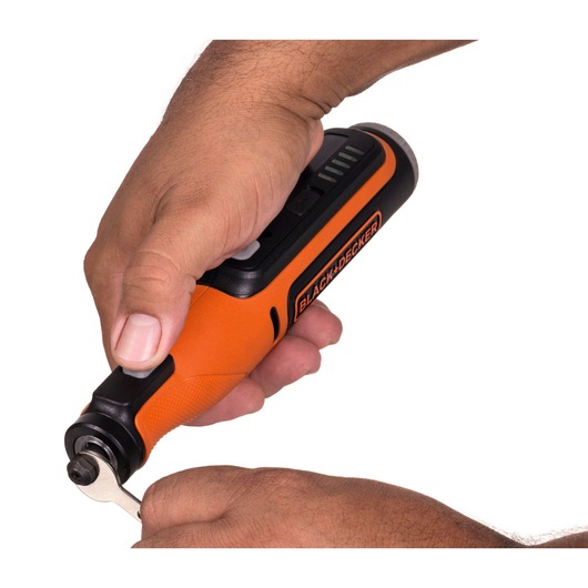 Photo of BLACK+DECKER BCRT8K35 orange cordless rotary tool in hand, close-up showing front side.