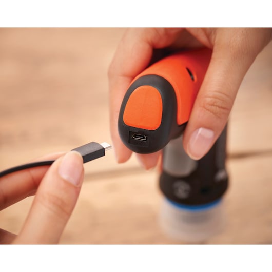 BLACKDECKER BCRTA601I tool close-up showing USB charging port with cable, photography category.