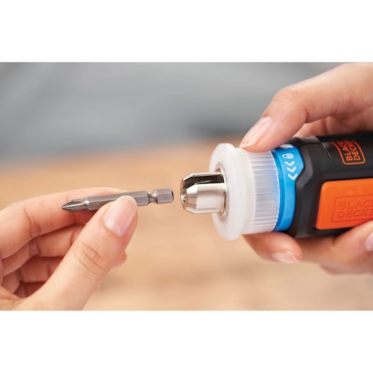 Photo of BLACKDECKER BCRTA601I screwdriver being fitted with a drill bit, close-up hand view.