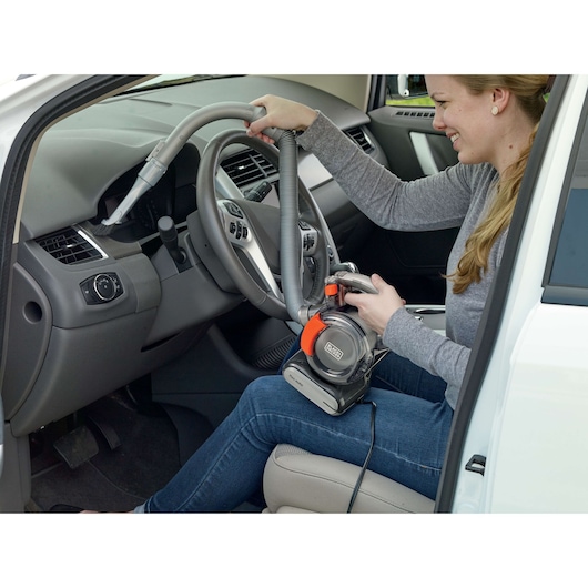 BLACKDECKER BDCV560F-LA handheld vacuum cleaner used for cleaning car interior.