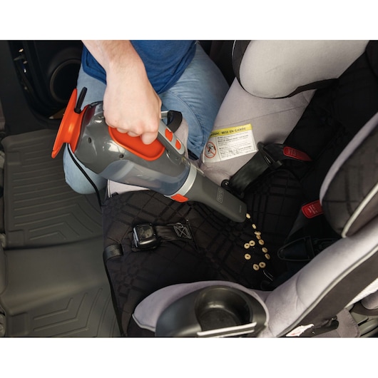 BLACKDECKER BDCV610-LA handheld vacuum cleaner used to clean cereal from car seat.