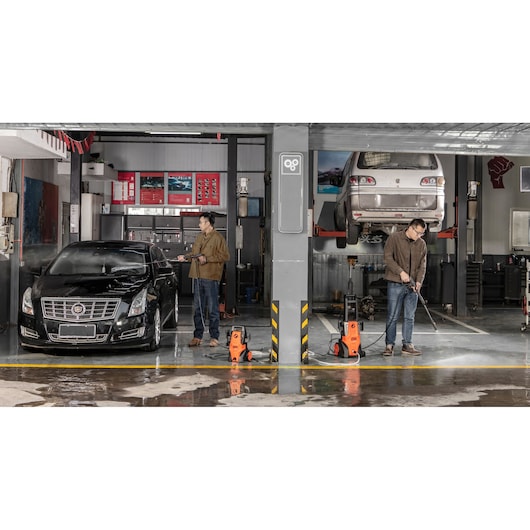 BLACKDECKER BEPWB2000 pressure washers in use cleaning cars in a professional garage, front view.