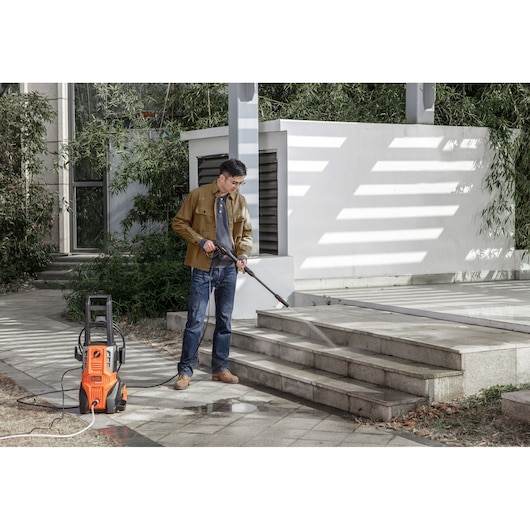 BLACKDECKER BEPWB2000 pressure washer in use cleaning outdoor stone steps.